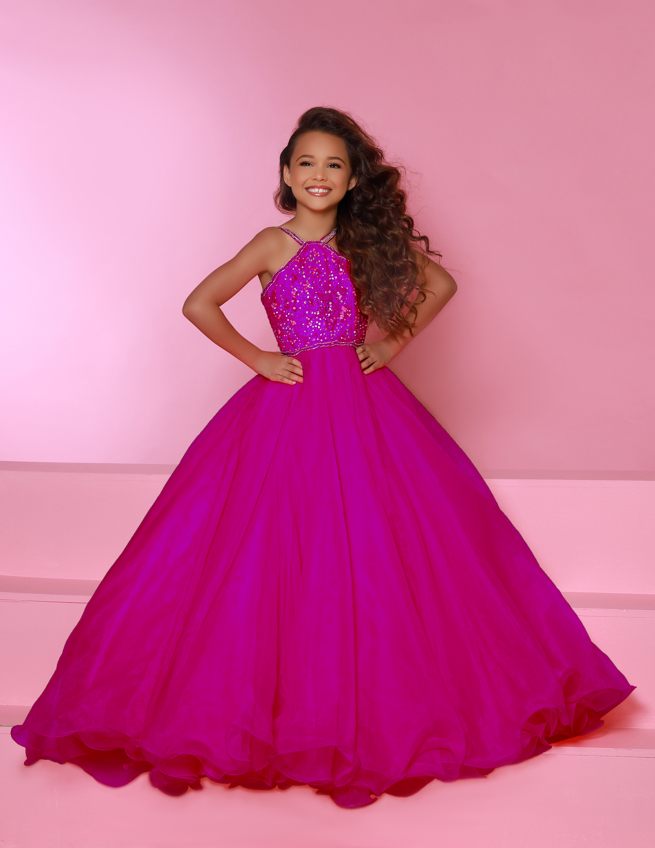 Hot pink sugar kayne girls pageant ball gown with sequin halter bodice and full organza skirt, perfect for glitz pageants, formal portraits, and runway competition.